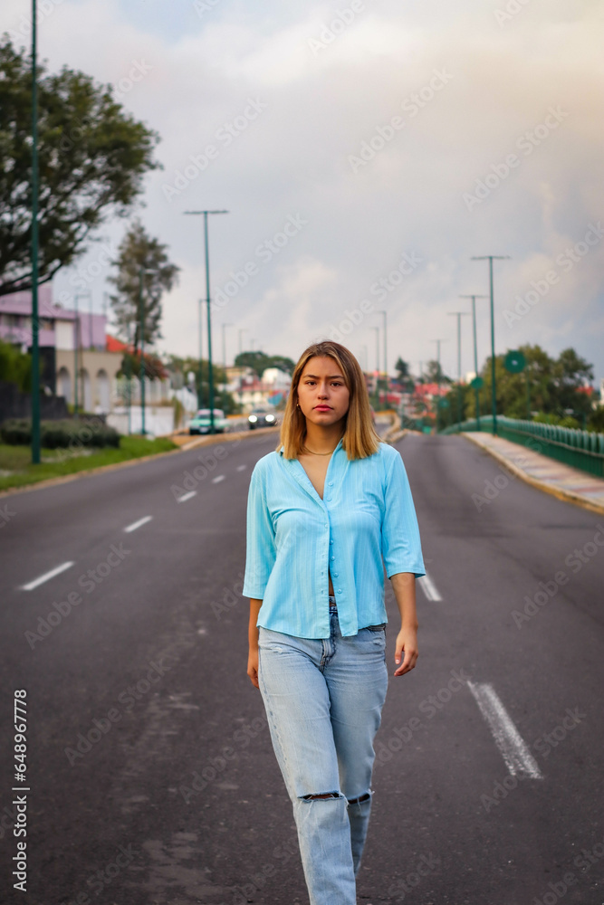 Confident Latin Female Striding Down the Middle of the Road Confident Latin Female Striding Down the Middle of the Road
