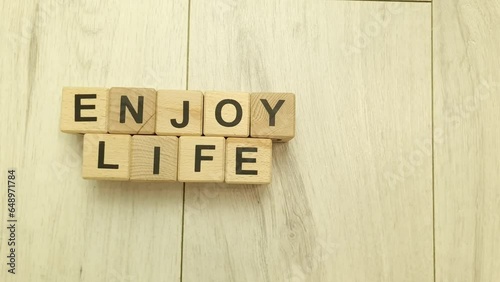 Enjoy life text from wooden blocks. Lifestyle, inspiration concept