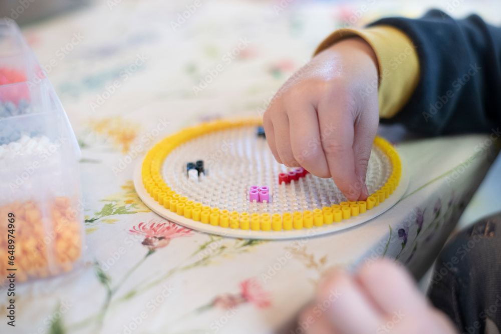 hands of a child beading hands of a child beading