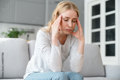 Canvas Print Stressed, tired woman with closed eyes feeling strong headache pain