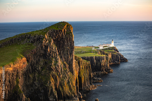 Sunset over the sea at Neist Point lighthouse on the isle of Skye photo