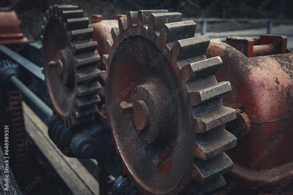 Close-up of Durable Metallic Machinery in Construction. Metalwork equipment in close-up view, featuring alloy iron. Mechanical red cogwheel in an industrial machine. Close-up of Durable Metallic Machinery in Construction. Metalwork equipment in close-up view, featuring alloy iron. Mechanical red cogwheel in an industrial machine.