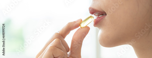 Nourishing the Body, Embracing Wellness: A Person Taking Fish Oil Supplements for Optimal Health and Vitality