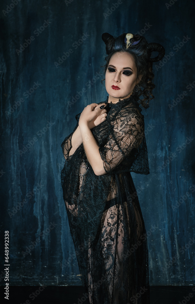 Beautiful woman witch with horns wearing black lacy dress Beautiful woman witch with horns wearing black lacy dress