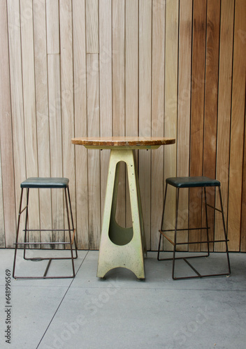 pair of barstools and a high top table on the back porch