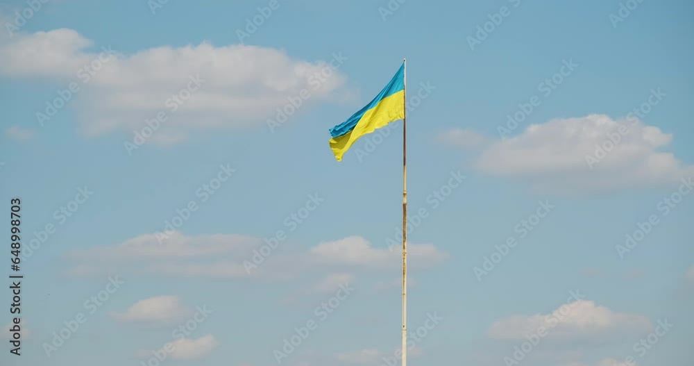 Ukraine flag wave on blue sky background. Natural yellow blue Ukrainian flag wind waving in flagpole on bright sky backdrop, copy space for text. Nation country independence. Patriotic sign 4k footage Ukraine flag wave on blue sky background. Natural yellow blue Ukrainian flag wind waving in flagpole on bright sky backdrop, copy space for text. Nation country independence. Patriotic sign 4k footage