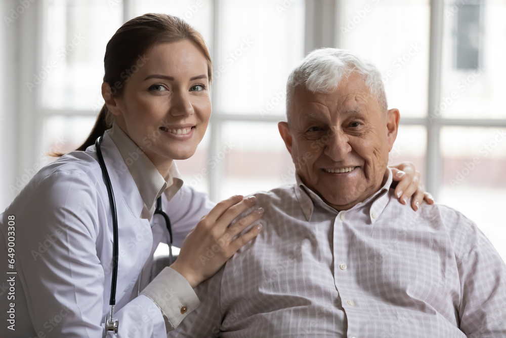 Portrait of smiling female nurse hug support optimistic senior 80s man client in retirement house, happy woman doctor or caregiver show care help comfort mature old male patient in hospital Portrait of smiling female nurse hug support optimistic senior 80s man client in retirement house, happy woman doctor or caregiver show care help comfort mature old male patient in hospital