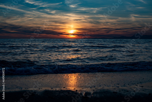 Italian sunset on the beach in landscape, Capri and Ischia in background