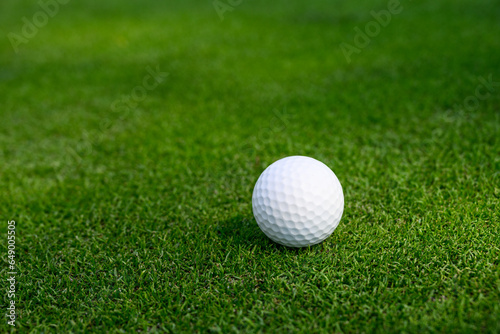 Closeup of white golf ball on a putting green 