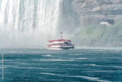 Tour boat sailing towards huge water flows down the waterfall, Horseshoe Water Fall in Niagara