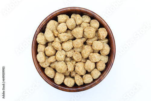 Soya chunks in a wooden bowl on white background top view  photo