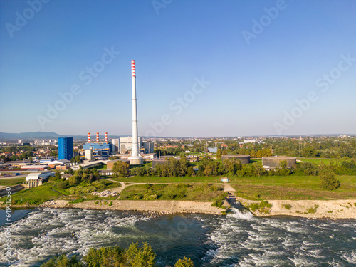 Fototapeta Naklejka Na Ścianę i Meble -  Drone view of Zagreb city heating plant, rising above small houses and streets, built on the Sava river embankment