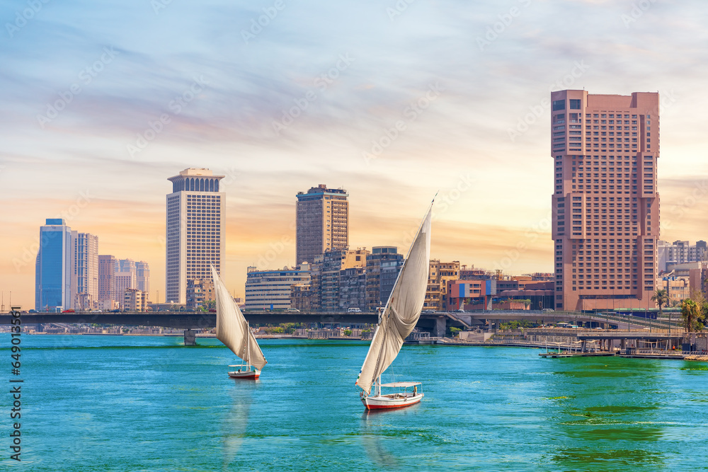 Typical boats in the Nile river and fancy buildings of Cairo, Egypt