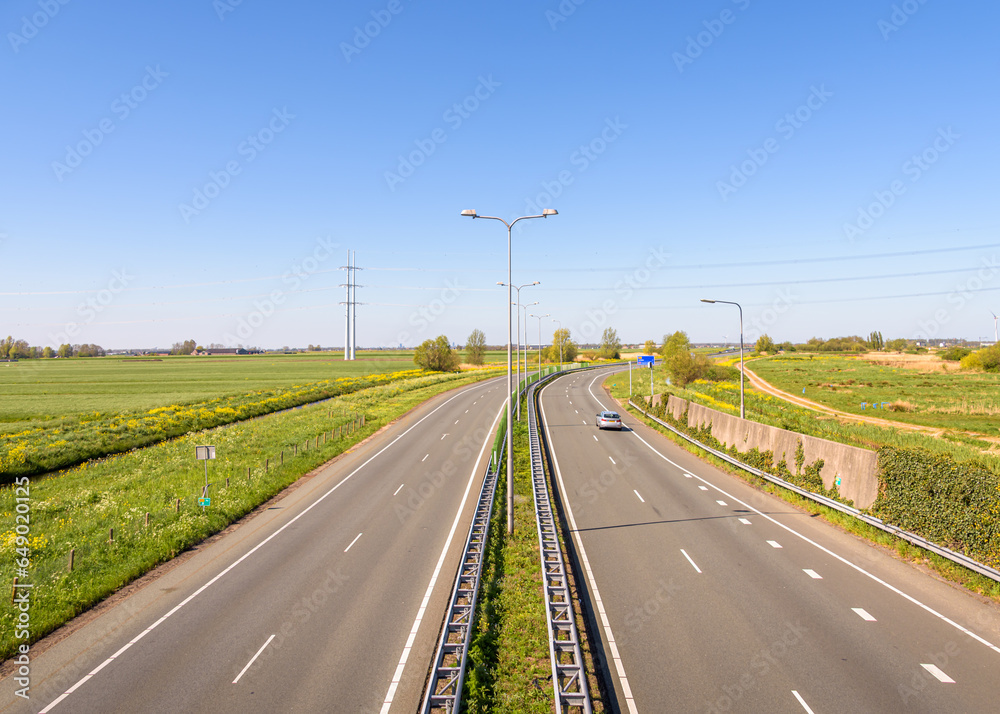 An empty rural road in a polder landscape
