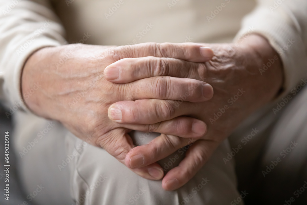 Close up of elderly 80s man sit join hands think of life problems, feel lonely anxious in retirement house, thoughtful mature grandfather lack communication or help, miss or mourn alone at home Close up of elderly 80s man sit join hands think of life problems, feel lonely anxious in retirement house, thoughtful mature grandfather lack communication or help, miss or mourn alone at home
