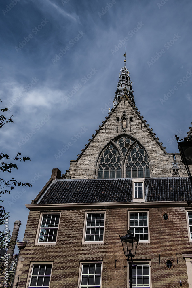 Amsterdam Old Church (Oude Kerk), oldest parish church, founded in 1213. Oude Kerk stands in Amsterdam De Wallen district on Old Church's Square (Oudekerksplein). Amsterdam, The Netherlands. Amsterdam Old Church (Oude Kerk), oldest parish church, founded in 1213. Oude Kerk stands in Amsterdam De Wallen district on Old Church's Square (Oudekerksplein). Amsterdam, The Netherlands.