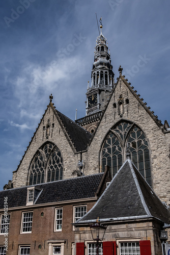 Amsterdam Old Church (Oude Kerk), oldest parish church, founded in 1213. Oude Kerk stands in Amsterdam De Wallen district on Old Church's Square (Oudekerksplein). Amsterdam, The Netherlands. photo