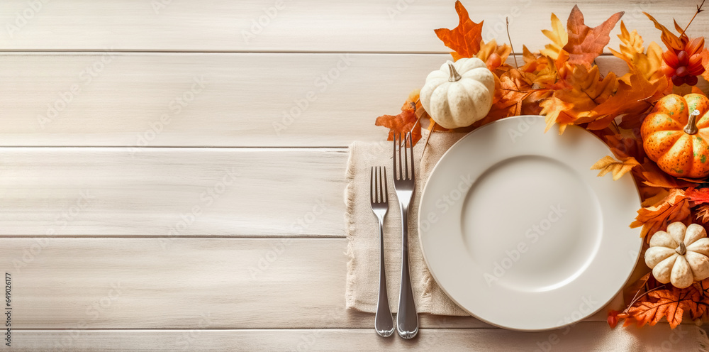 Thanksgiving fall place setting with cutlery and fall leaf arrangement, top view, flat lay. Autumn place setting with fall leaves, napkin and pumpkins. - obrazy, fototapety, plakaty 