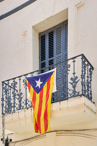 Catalan independence flag hanging from a window demanding the independence of Catalonia photo