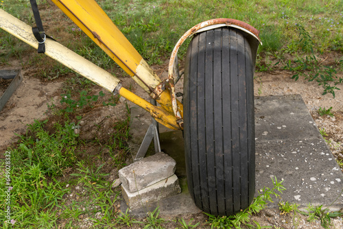 yellow landing gear of an old propeller engine with rubber tires