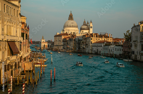 Venice canal with boats at sunset