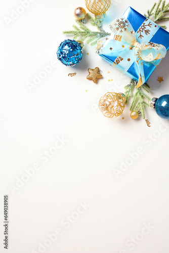 Luxury Christmas decorations, gift box and fir branches isolated on white background. Xmas vertical banner design.