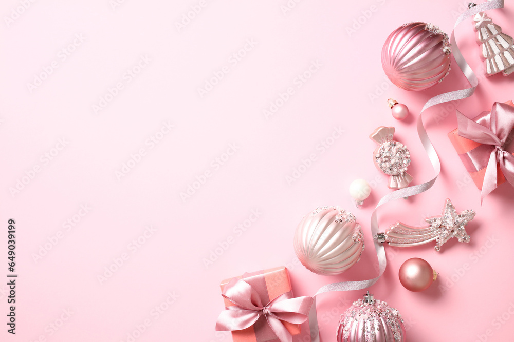 Christmas banner design. Top view photo of stylish Christmas decorations, ribbon, balls, gift boxes on pink background. Christmas banner design. Top view photo of stylish Christmas decorations, ribbon, balls, gift boxes on pink background.