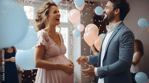 Attractive pregnant couple laughing at baby celebration or reveal party
