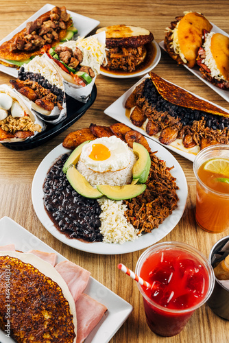 Venezuelan food on a table, arepas, tostones, cachapas, empanadas. typical Venezuelan gastronomy photo