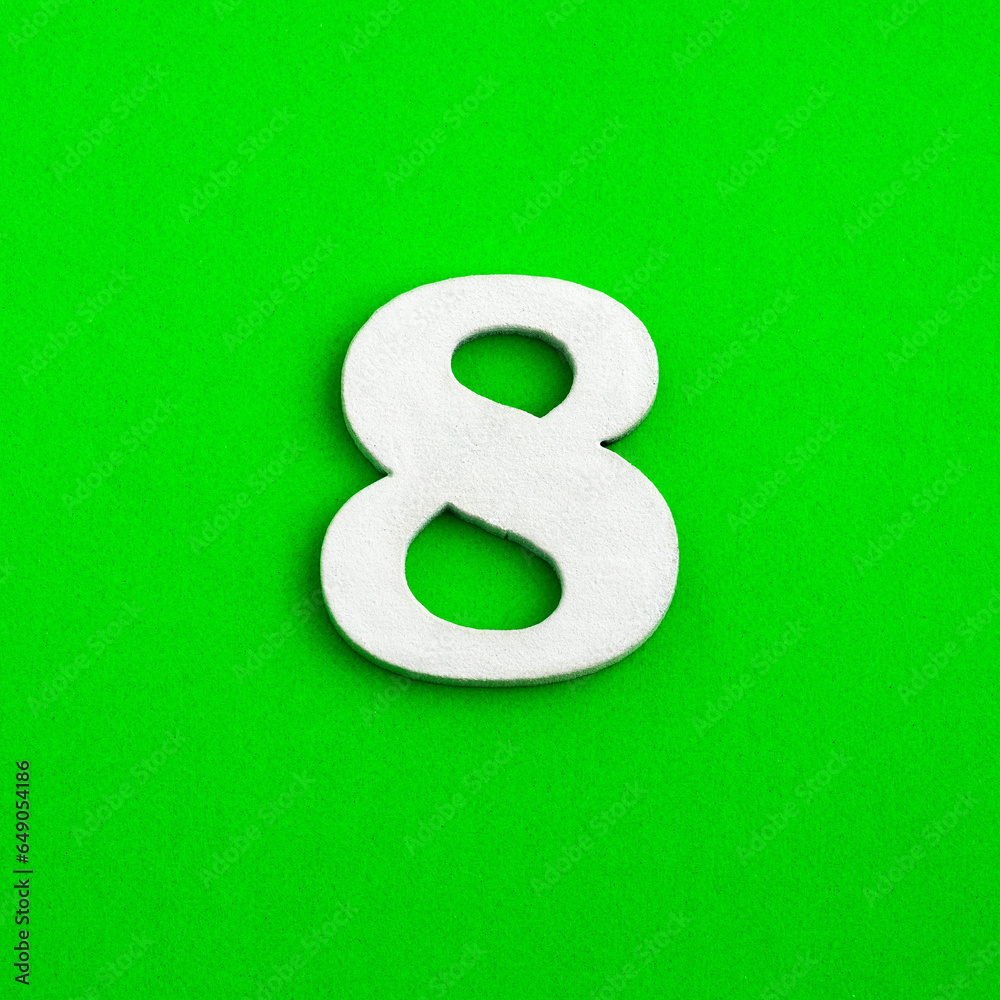 Number eight - white number in wood on green background Number eight - white number in wood on green background