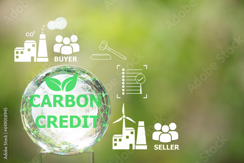 Carbon Credit text on crystal globe and icons. And can be traded in the carbon market with organizations that want carbon credits to offset greenhouse gas emissions. photo