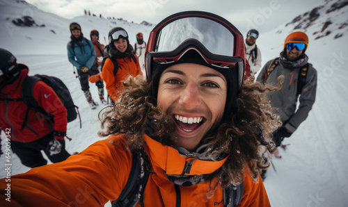 Selfie photo of beautiful happy girl with ski goggles, skiclothing and helmet, skiing with good friends,