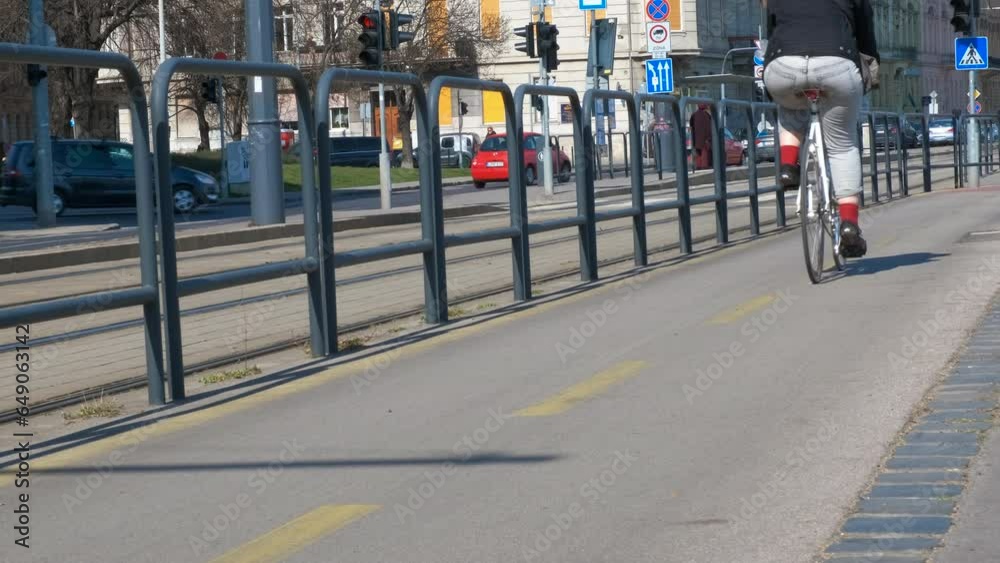 custom made wallpaper toronto digitalRiding on bicycle lane against city road. A view of people rides bike on the cyclist path in the city during day time.