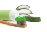 Toothbrush with toothpaste and green aloe leaves on white background