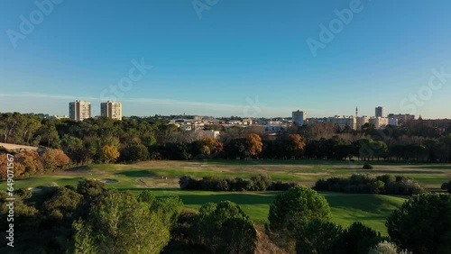 Montpellier's contrasts: Aerial views of serene Golf Fontcaude juxtaposed with bustling la Mosson.
 photo