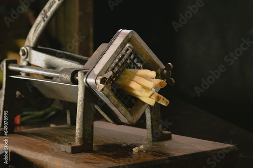 manual machine with sharp grate to cut potatoes or vegelaten in the shape of a stick