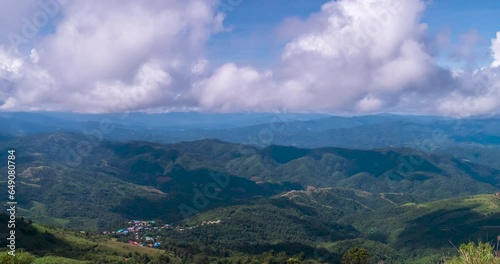 Timelapse Mountain landscape foggy winndy range mountain green landscape asian farm. Beautiful landscape mountain green field meadow white cloud blue sky on sunrise. Countryside sun light heaven photo