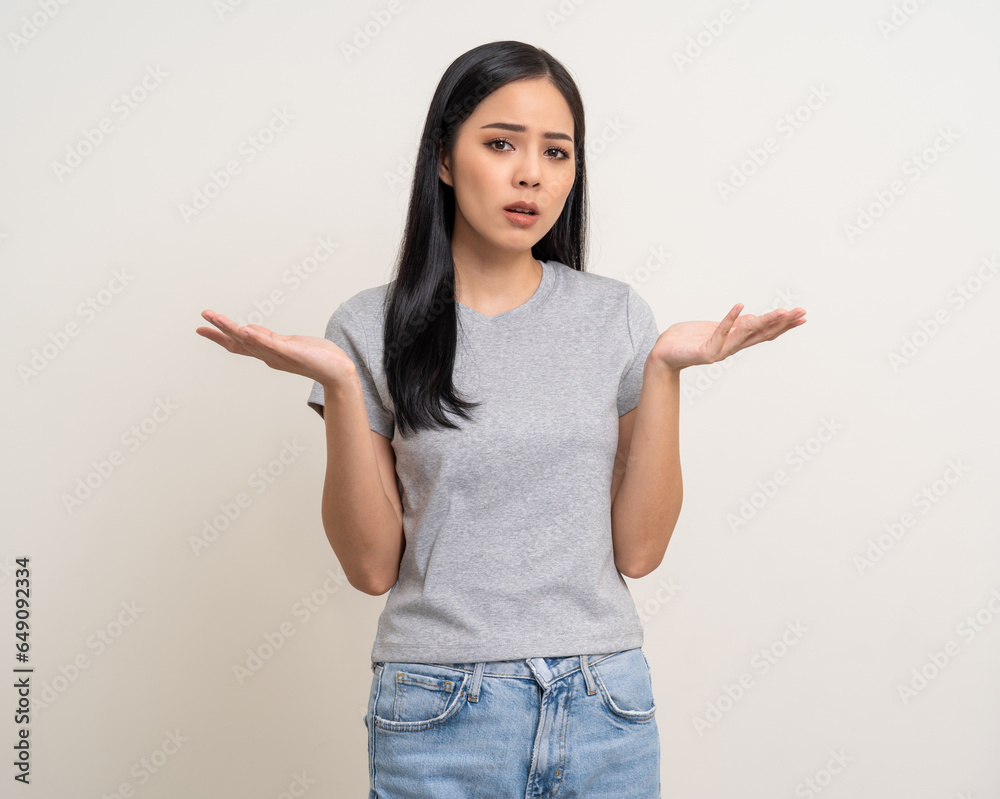 Upset confused bad emotional and thinking asian woman. Unhappy stressed female. Young latin lady standing feeling depressed dramatic scene looking at camera on isolated background. Upset confused bad emotional and thinking asian woman. Unhappy stressed female. Young latin lady standing feeling depressed dramatic scene looking at camera on isolated background.