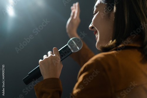 Close up woman hand holding High quality dynamic microphone and singing song or speaking talking with people on isolated white background. Woman testing microphone voice for interview