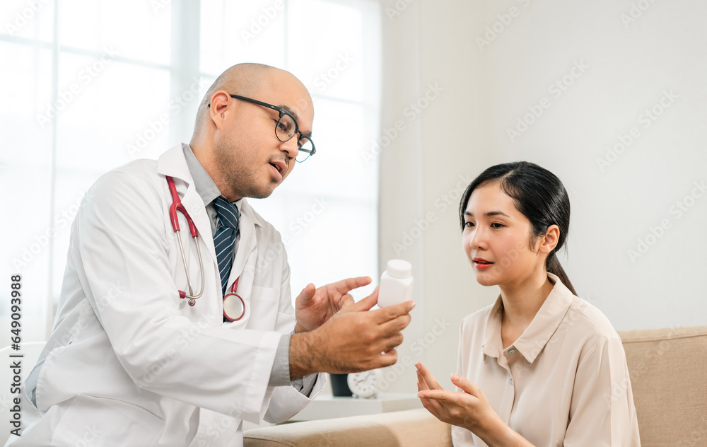 Asian Doctor and patient discussing consulting with digital tablet. Patient meet talking with Doctor giving pills bottle to woman at hospital. Medicine and health care treatment result in clinic Asian Doctor and patient discussing consulting with digital tablet. Patient meet talking with Doctor giving pills bottle to woman at hospital. Medicine and health care treatment result in clinic