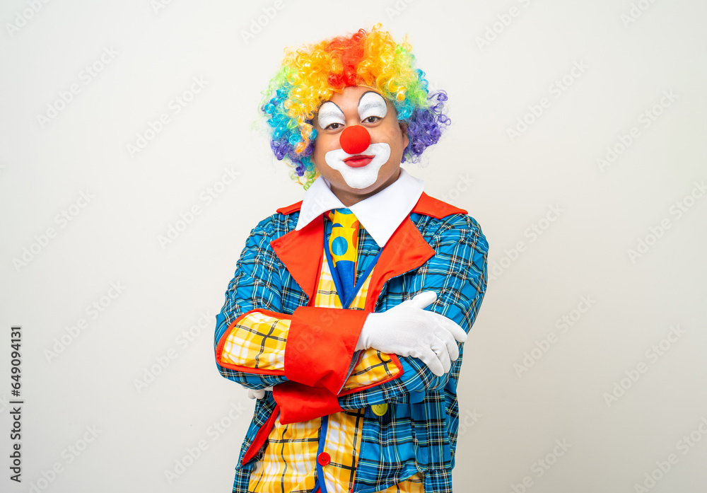 Mr Clown. Portrait of Funny face Clown man in colorful uniform standing arms crossed smiling to camera. Happy expression male bozo in various pose on isolated background. Mr Clown. Portrait of Funny face Clown man in colorful uniform standing arms crossed smiling to camera. Happy expression male bozo in various pose on isolated background.