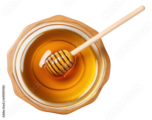 Glass bowl of pure honey with honey dipper isolated.