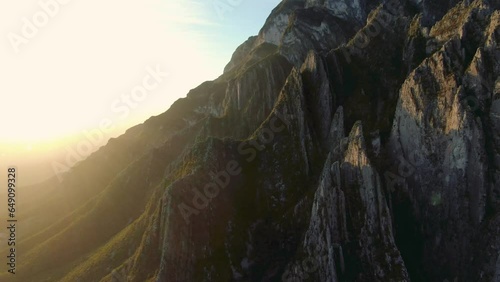 aerial shot of mountain ridge with sunflare, river valley, Portrero Chico, hidalgo climbing mountain, sunrays, green mountains near hidalgo, great rock climbing, Mexican state of Nuevo León. photo