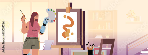 disabled woman artist with replaced robotic leg and arm girl drawing on canvas people with disabilities concept modern studio interior