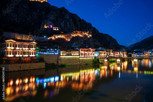 Amasya,TURKEY old riverside Turkish(ottoman) city buildings and its reflection on water,sunny summer day.Amasya is city of princes of ottoman. ottoman Princes were educated in Amasya photo