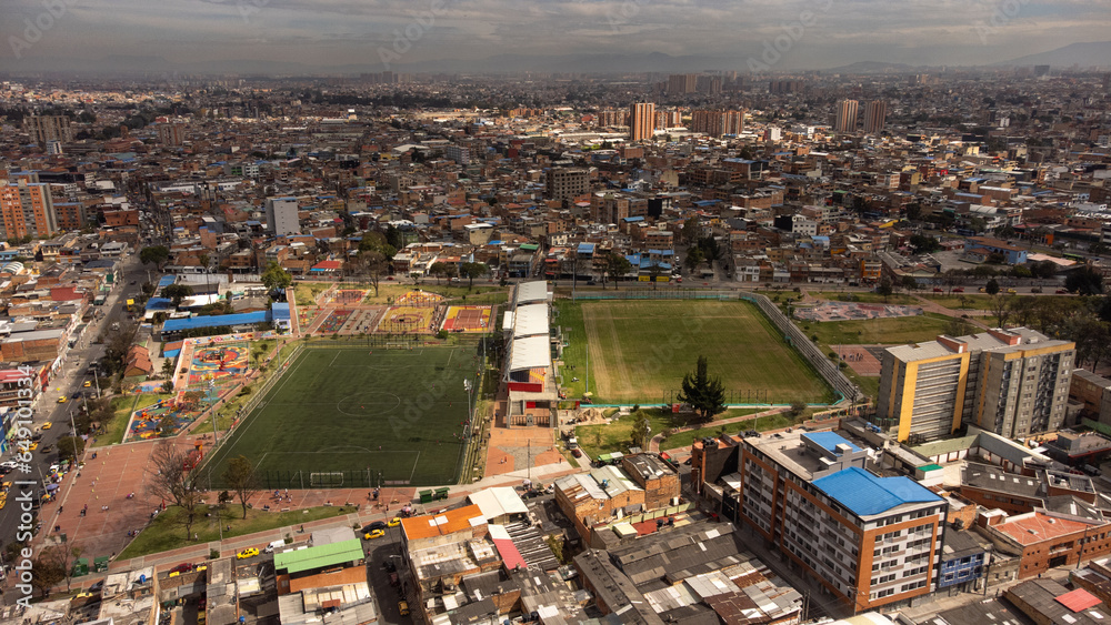 aerial view of a small stadium in Bogotá with buildings in the background in the morning