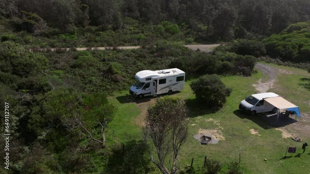 Motorhome on campground on a sunny day at Gillard's campground in Australia. Drone panning shot Motorhome on campground on a sunny day at Gillard's campground in Australia. Drone panning shot