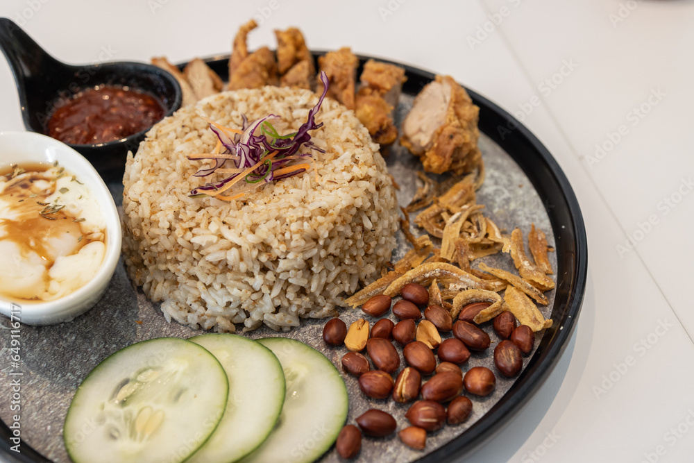 Close-up image of delicious Nasi lemak with fried chicken serve on plate Close-up image of delicious Nasi lemak with fried chicken serve on plate