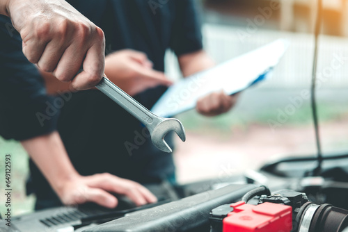 Auto mechanic working in garage Technician Hands of car mechanic working in auto repair Service and Maintenance car check.