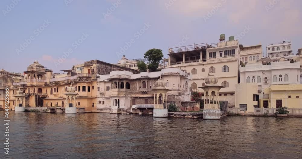 Udaipur Lal Ghat old houses and haveli view from boat. Rajput architecture of Mewar dynasty rulers tourist Indian landmark. Incredible India. Horizontal camera truck Udaipur Lal Ghat old houses and haveli view from boat. Rajput architecture of Mewar dynasty rulers tourist Indian landmark. Incredible India. Horizontal camera truck